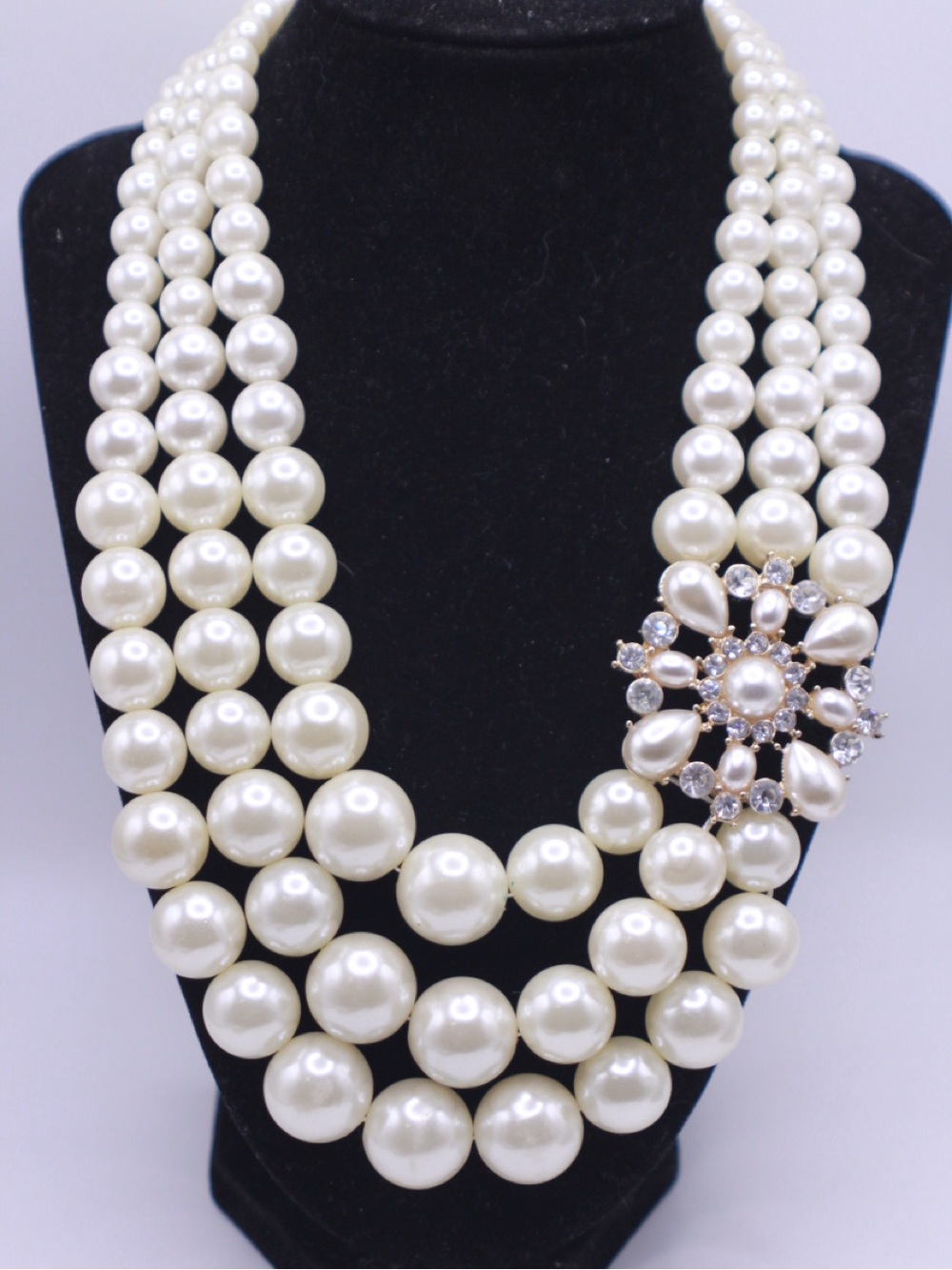 Modern unsigned triple-strand faux pearl rhinestone statement necklace